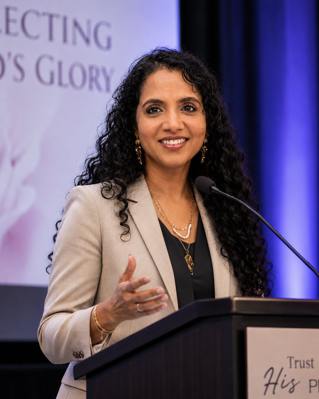 Elizabeth Nuthalapaty speaking at a conference podium
